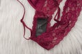 Black tag with sizes on burgundy lace underwear. Fashion concept