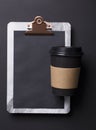 Black take away coffee cup and clipboard blank menu Royalty Free Stock Photo