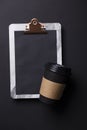 Black take away coffee cup and clipboard blank menu Royalty Free Stock Photo