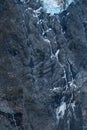 Black tall cliff with ice and waterfall begining of the glacier in Mt Cook National Park. I Royalty Free Stock Photo