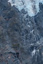 Black tall cliff with ice and waterfall begining of the glacier in Mt Cook National Park. I Royalty Free Stock Photo