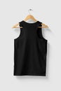 Black Tank Top Shirt mockup on wooden hanger isolated on light grey background rear side view. Royalty Free Stock Photo