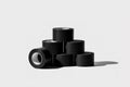 Black tape rolls stacked creatively on a light background highlighting their texture and design Royalty Free Stock Photo