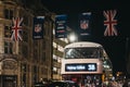 Black taxi and bus on Regent Street decorated with NFL flags, London, UK Royalty Free Stock Photo