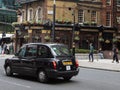 Black Taxi in London Traffic Road near Palmer Street, England