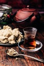 Black tea in armudu glass and spoonful of halva Royalty Free Stock Photo