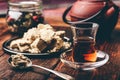 Black tea in armudu glass and spoonful of halva Royalty Free Stock Photo