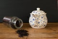 Black tea in a bottle and a teapot of flowers Royalty Free Stock Photo