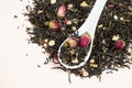 Black Tea Composition with Ginseng Pieces and Tea Roses. Royalty Free Stock Photo
