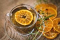 Black tea. Cup of tea with dried orange. Herbal tea with dried citrus. Black tea cup on wooden background