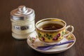 Black tea cup and sugar bowl on the wooden table Royalty Free Stock Photo