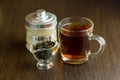 Black tea cup and sugar bowl on the wooden table Royalty Free Stock Photo