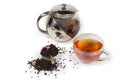 Black tea in cup and teapot, tea leaves with additives Royalty Free Stock Photo