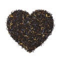 Black tea with dried flower leaves in heart shape isolated on white background Royalty Free Stock Photo