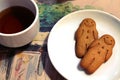 Black tea and gingerbread men cookies in a white bowl in a cafe Royalty Free Stock Photo