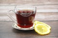Black tea in a glass mug and a slice of lemon Royalty Free Stock Photo
