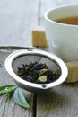 Black tea leaves in a metal strainer