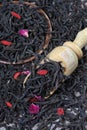 black tea leaves with rose petals and goji berries in a scoop. Royalty Free Stock Photo