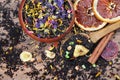 Black tea leaves in a wooden spoon. blended tea with flower petals and pieces of dried fruit on a wooden table. black blended tea Royalty Free Stock Photo