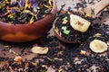 Black tea leaves in a wooden spoon. blended tea with flower petals and pieces of dried fruit on a wooden table. black blended tea Royalty Free Stock Photo