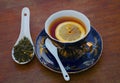 Black tea with lemon on a wooden table on a summer day