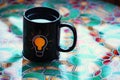 Black tea mug bulb symbol water table