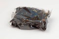 Black tea packaging on a white background. Long leaf tea with rose hips, apples and flower petals, packed in a transparent package