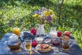 Tea, pancakes, milk and jam on the breakfast table in the autumn garden, close up Royalty Free Stock Photo