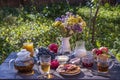 Tea, pancakes, milk and jam on the breakfast table in the autumn garden, close up Royalty Free Stock Photo