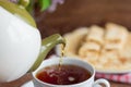 Black tea is poured into a Cup for Breakfast,close-up Royalty Free Stock Photo