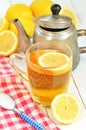 Black tea with slice of lemon in mug, old teapot and sugar Royalty Free Stock Photo