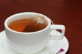 Black tea with tea bag in a white color cup macro Royalty Free Stock Photo