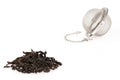 Black tea, and tea strainer with chain, isolated on a white background. Royalty Free Stock Photo