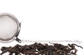 Black tea, and tea strainer with chain, on a white background. Royalty Free Stock Photo