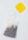 Black tea teabags with yellow tag flat on white background