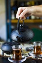 Black tea and teapot in hand, Turkish tea glasses