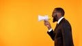 Black team leader making announcement in megaphone, stressful job, deadline
