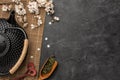 Black teapot with sakura branch and green tea on a dark background. Top view with copy space Royalty Free Stock Photo