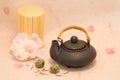 Black teapot, tea and peony