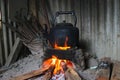 Black teapot on a traditional Sundanese wood-fired stove called hawu in a traditional kitchen. Royalty Free Stock Photo