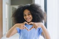 Black teen girl afro hair happy smile with hand love heart sign