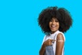 Black teen girl smile and points to her arm with vaccine sticker, she does not wear face shield, Royalty Free Stock Photo