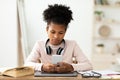 Black Teen Girl Using Phone Sitting At Laptop At Home Royalty Free Stock Photo
