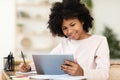 Black Teenager Girl Using Tablet Computer Learning Distantly At Home Royalty Free Stock Photo