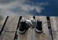 Black teenager's shoes standing on the bridge edge, choice concept Royalty Free Stock Photo