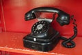 Black telephone set in red phone box Royalty Free Stock Photo