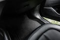 Black textile car mat in black auto interior. Royalty Free Stock Photo