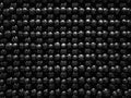 Black textured decorative background of small black smooth balls