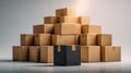 Black textured parcel standing out in front of neat pyramid stack of brown paper shipping boxes on smooth surface against neutral Royalty Free Stock Photo