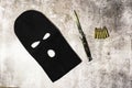 Black thieving balaclava with automatic knife and war bullets Royalty Free Stock Photo